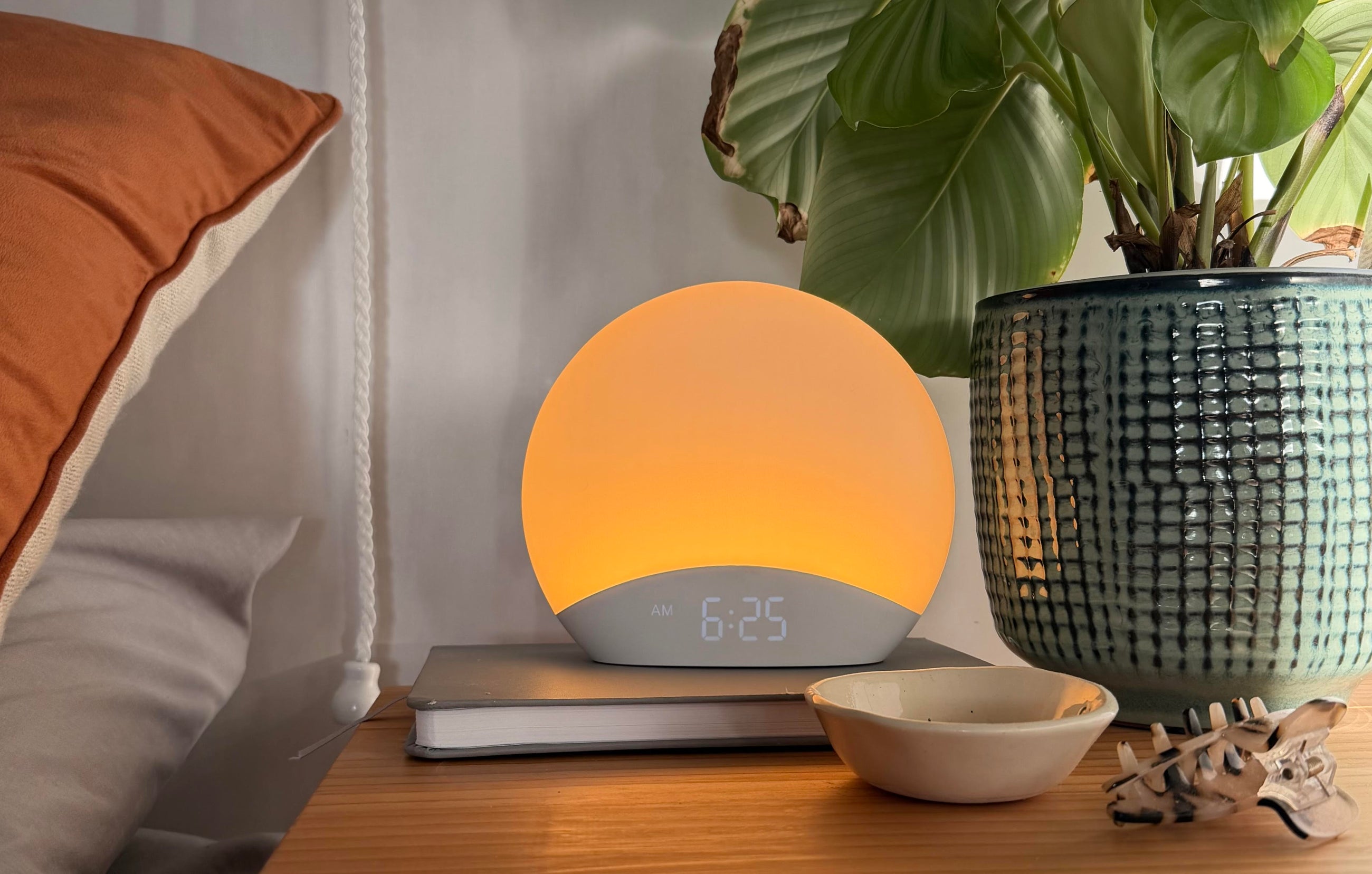 The Sunni Light glowing on a styled bedside table